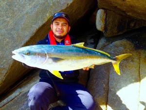 Nhadier Addala holding a yellowtail king fish