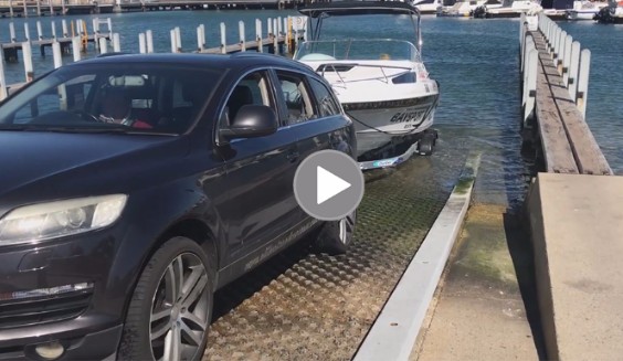 Car and boat on boat ramp